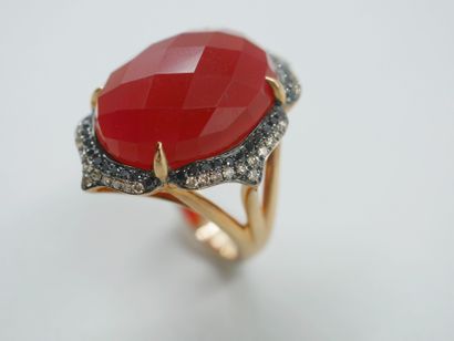 null 18k rose gold and rhodium ring set with a faceted red agate in the center of...