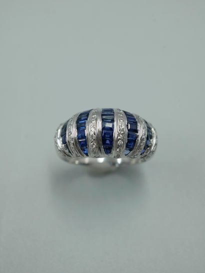 null 18K white gold dome ring set with lines of calibrated sapphires alternating...