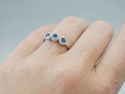 null Trilogy ring in 18k white gold with three circular motifs centered on sapphires...