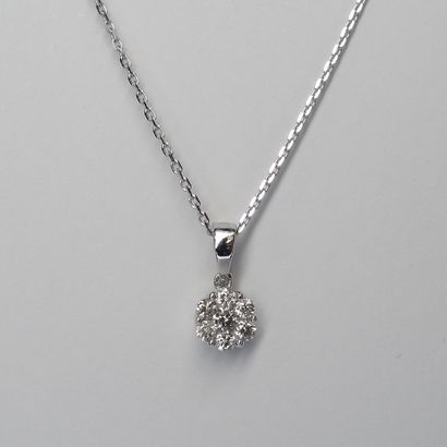 null Flower pendant in 18k white gold set with seven brilliant cut diamonds. Accompanied...