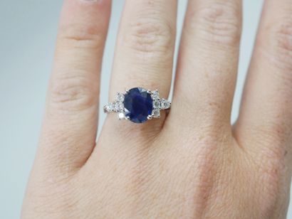 null 18k white gold ring set with an oval sapphire of about 2cts and eight diamonds....