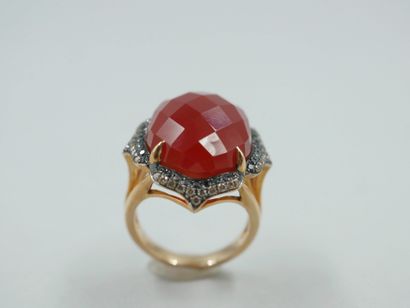 null 18k rose gold and rhodium ring set with a faceted red agate in the center of...
