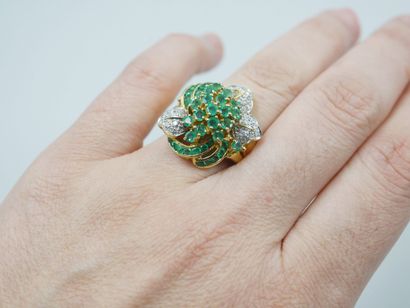 null 18k yellow and white gold flower ring set with round and calibrated emeralds...