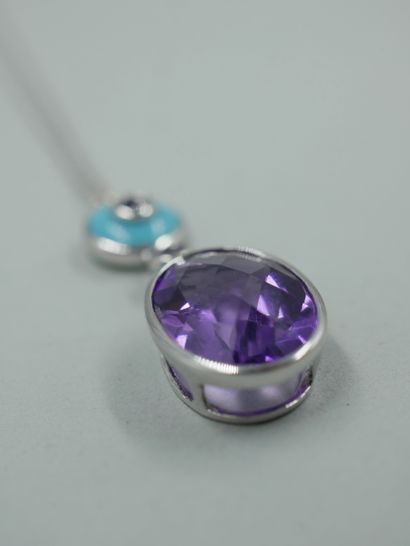 null 18k white gold pendant set with a turquoise cabochon centered on an amethyst...