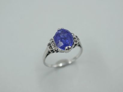 null Platinum ring set with an oval tanzanite of about 4.50cts and small diamonds....