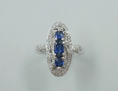 null Marquise ring in 18k white gold set with three oval sapphires in a diamond setting....