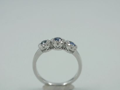 null Trilogy ring in 18k white gold with three circular motifs centered on sapphires...
