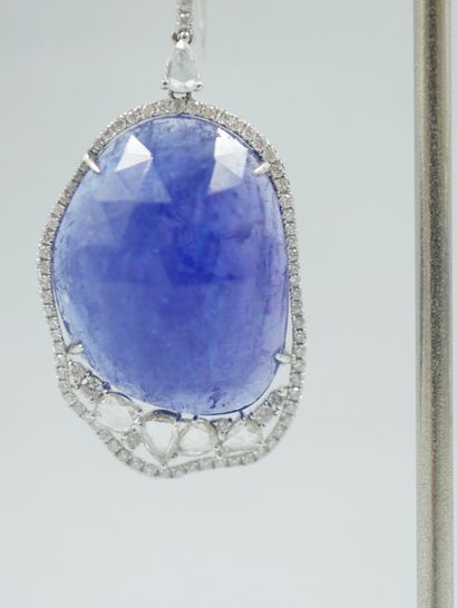 null Pair of 18k white gold earrings set with a large faceted tanzanite highlighted...