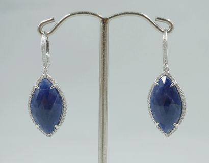 null Pair of 18k white gold earrings holding two faceted marquise-cut sapphires for...