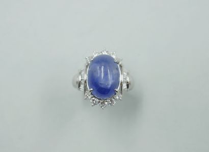 null 18k white gold ring set with a cabochon star sapphire of 15cts circled with...