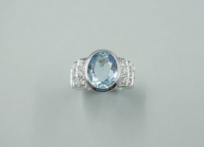 null 18k white gold band ring centered with an oval aquamarine of about 3cts in a...