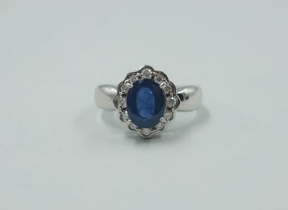 null Flower ring in 18k white gold with an oval sapphire of about 2.50cts in a diamond...