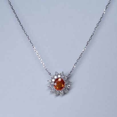 null 18k white gold pendant centered with an oval cut orange sapphire in a diamond...