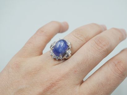 null 18k white gold ring set with a cabochon star sapphire of 15cts circled with...