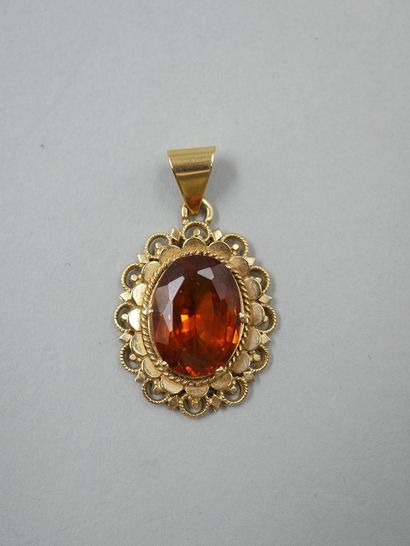 null 18k yellow gold pendant set with an oval orange topaz in an openwork setting....