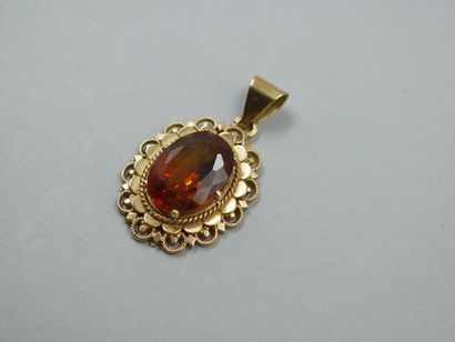 null 18k yellow gold pendant set with an oval orange topaz in an openwork setting....