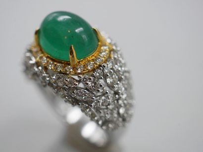 null Yellow gold and 18k white gold ring centered on a cabochon emerald of about...