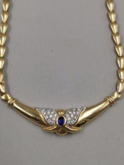 null Necklace in 18K gold centered with a synthetic sapphire, accosted by a diamond...