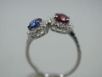 null 
A platinum Vous et Moi ring set with an oval ruby of about 1ct and an oval...
