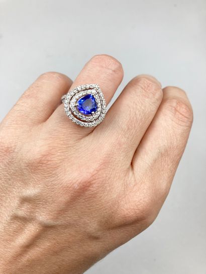 null 18k white gold ring set with a tanzanite of about 2cts in a double surround...