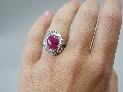 null 
Platinum skirt ring set with a cabochon ruby of about 6cts in a double setting...