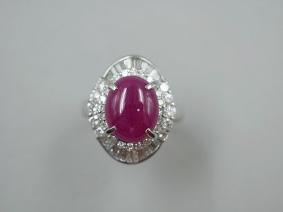 null 
Platinum skirt ring set with a cabochon ruby of about 6cts in a double setting...