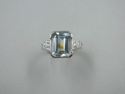 null 18k gold ring surmounted by an emerald-cut aquamarine of about 6 cts, with six...