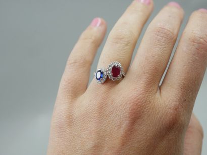 null 
A platinum Vous et Moi ring set with an oval ruby of about 1ct and an oval...