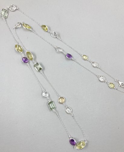 null Long silver necklace punctuated with various motifs set with multicolored stones.

Length...