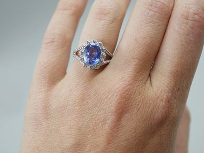 null 
Platinum pompadour ring set with an oval sapphire of about 4cts in a diamond...