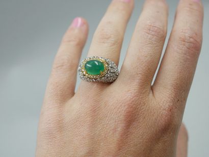 null Yellow gold and 18k white gold ring centered on a cabochon emerald of about...