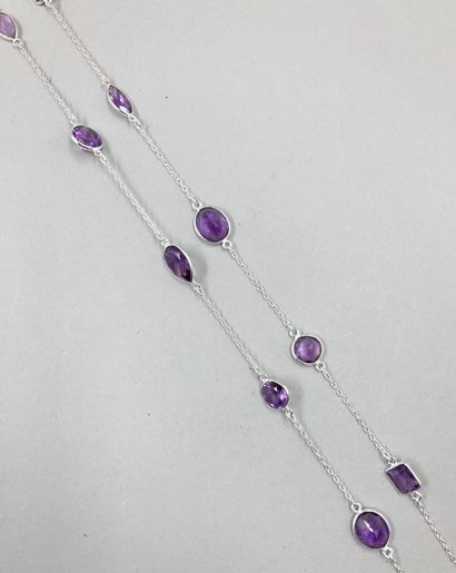 null Long silver necklace punctuated with various patterns set with faceted amethysts.

Length...