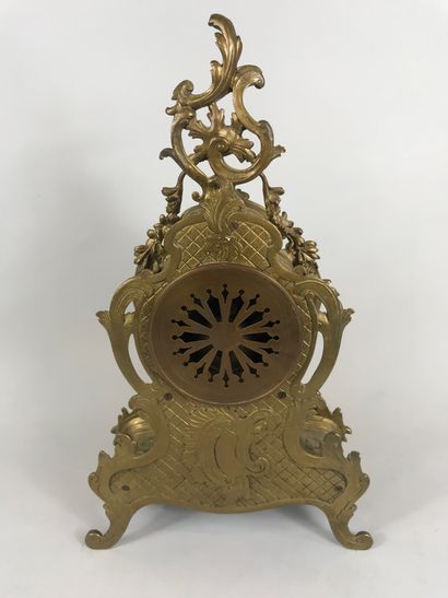 null Gilded bronze mantelpiece including a violin shaped clock decorated with interlacing...