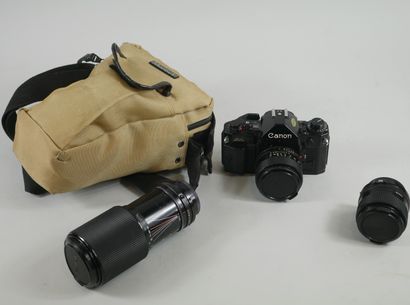 null Canon A-1 camera with two lenses 

In its case