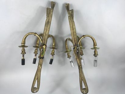 null Pair of sconces with three arms of light in gilded metal decorated with ribboned...