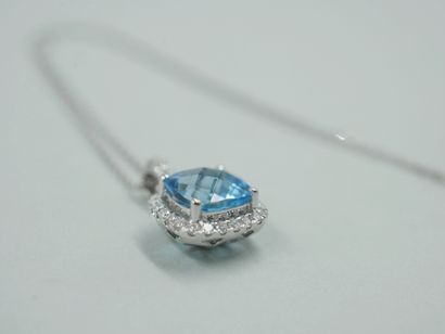 null 18k white gold pendant with a cushion-cut blue topaz of about 2cts encircled...