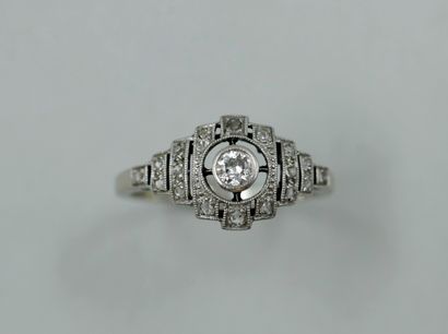 null 
Platinum ring topped by a diamond in an openwork setting set with small diamonds.

Period...