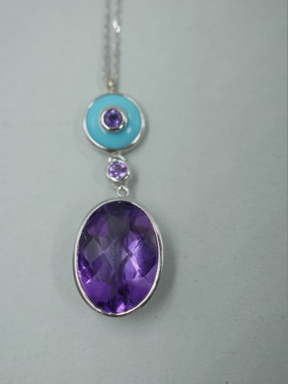 null 18k white gold pendant set with a turquoise cabochon centered on an amethyst...