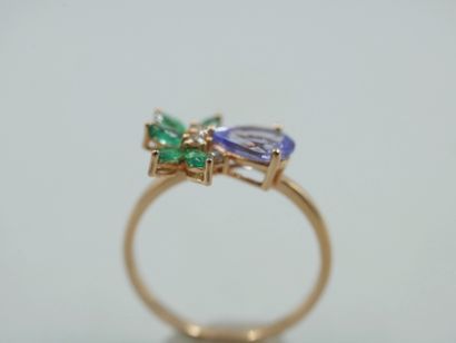 null 18k rose gold flower ring set with one pear-cut tanzanite, six navette-cut emeralds...