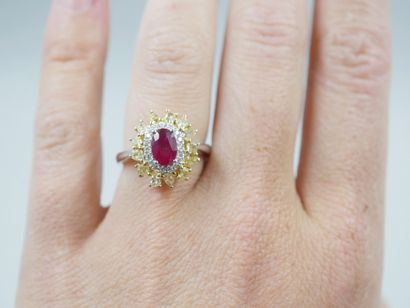 null Flower ring in 18k gold, centered on a 1ct oval ruby in a double border of brilliant-cut...