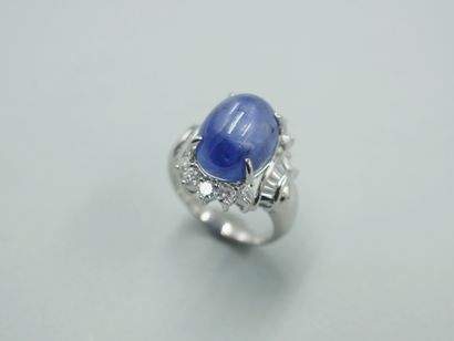 null 
Platinum ring set with a cabochon star sapphire of 15cts circled with brilliant-cut...