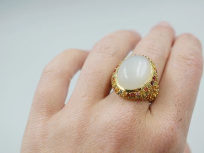 null Gold vermeil ring centered on a large oval cabochon moonstone in a paved surround...