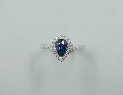 null 18k white gold ring set with a 1ct natural pear cut sapphire in a diamond setting....