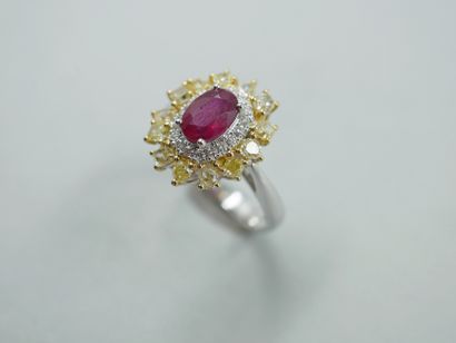 null Flower ring in 18k gold, centered on a 1ct oval ruby in a double border of brilliant-cut...