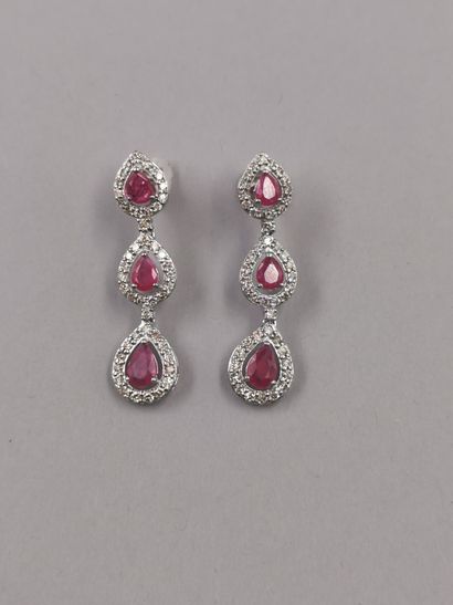 null A pair of 18k white gold earrings with three drop-shaped motifs set with rubies...