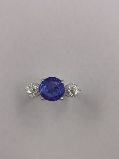 null 18k white gold ring centered on a round tanzanite of about 4.50cts with two...