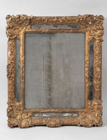  Mirror with gilded carved wood glazing, decorated with interlacing leaves on a background...