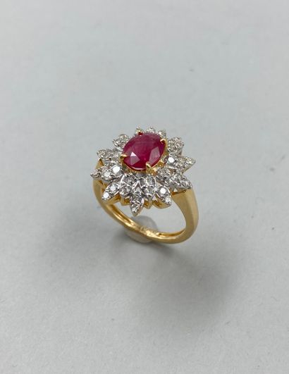 null 18k yellow gold flower ring set with a 1.40ct oval ruby in a double border of...