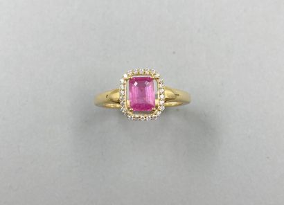 null A vermeil ring set with an emerald-cut pink sapphire surrounded by a line of...