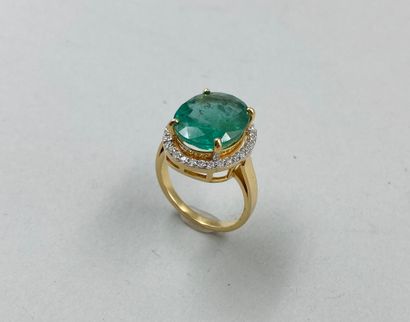 null An 18k yellow gold Pompadour ring set with a large oval emerald weighing approximately...